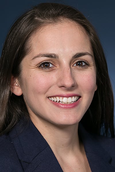 A person with brown hair smiling