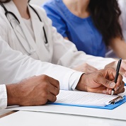 Image of a medical student writing with a pen