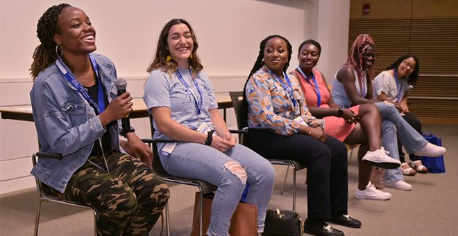 A group of student during a panel discussion at the three-schools orientation.