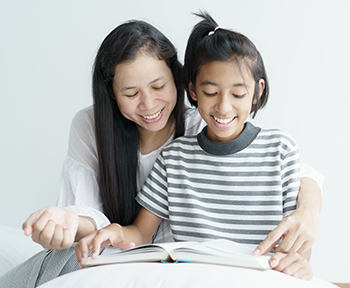 ethnic mother and young girl reading