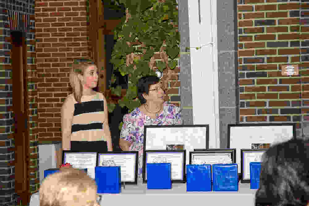 Gabi Carbone and Kathy Delongchamp with certificates and gifts