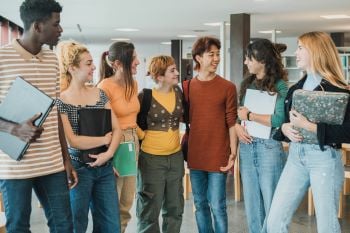 group of diverse teens in library