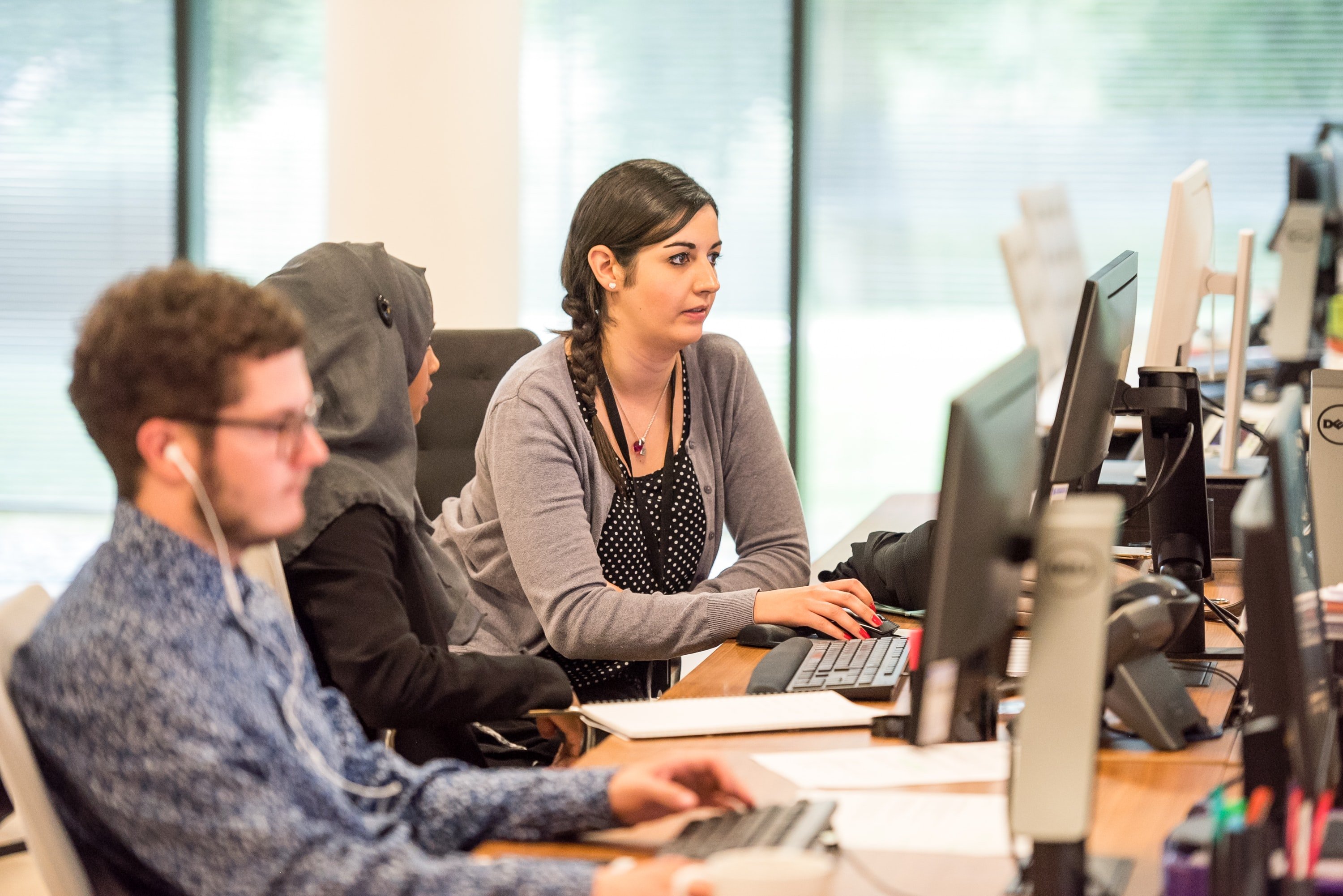 female boss with female employee in front of a computer