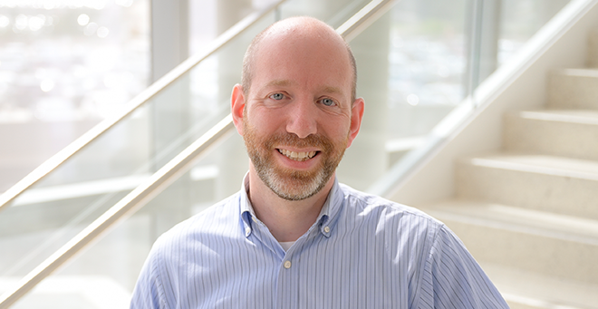 Jeffrey Driban standing in front of a staircase