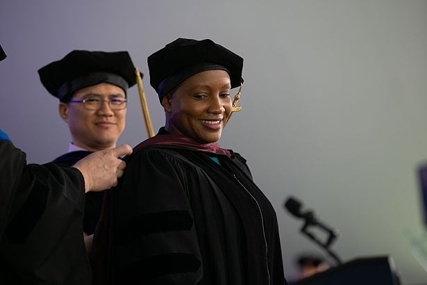 Graduating GSBS student Loretah Chibaya is hooded.