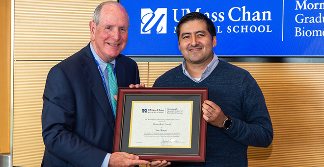 Chancellor Michael F. Collins standing next to Eric Romo  