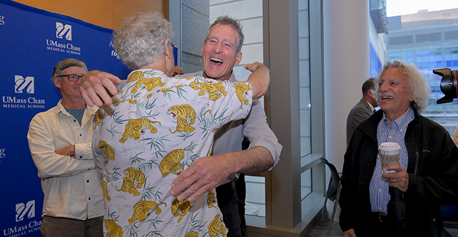 Two UMass Chan Nobel Prize winners in one photo: Victor Ambros embraces fellow Nobel Laureate and former mentee Craig Mello. Colleagues William Theurkauf, PhD, (far left) and Allan Jacobson, PhD, (far right) enjoy the moment.