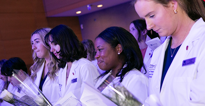 DNP students Leah Kachadorian, Isabella Joseph, Cynthia Delmas and Grace Cogan wearing their white coats