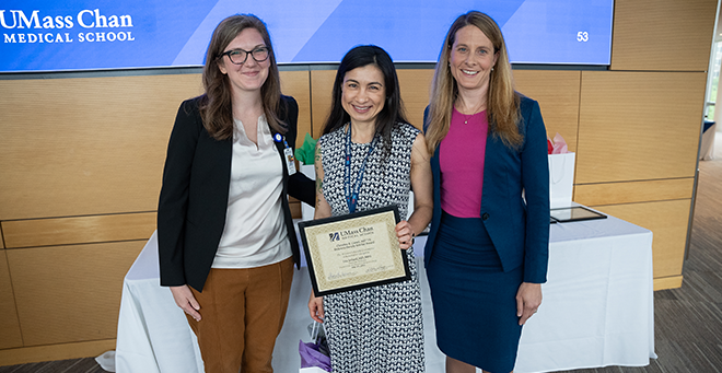 Group shot in conference room of award recipient and co-chairs