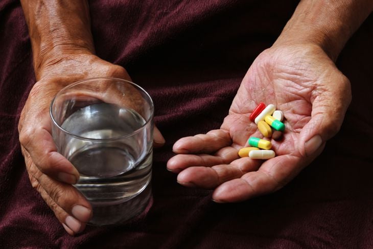 Hands holding pills